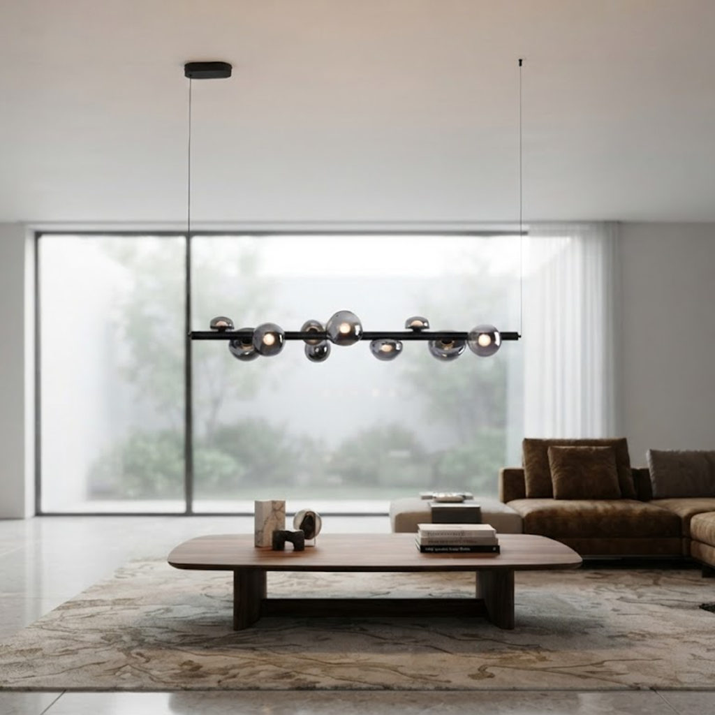 The Constellation smoky glass sphere linear chandelier hanging over a modern marble reception desk