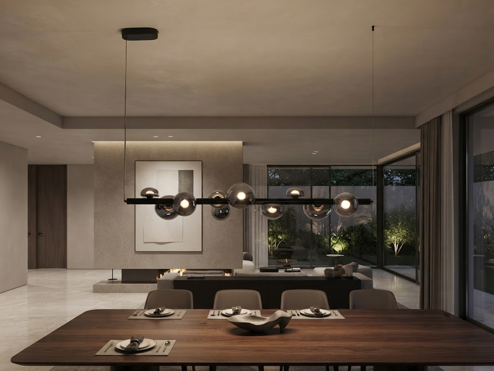 The Constellation smoky glass sphere linear chandelier hanging over a modern marble reception desk