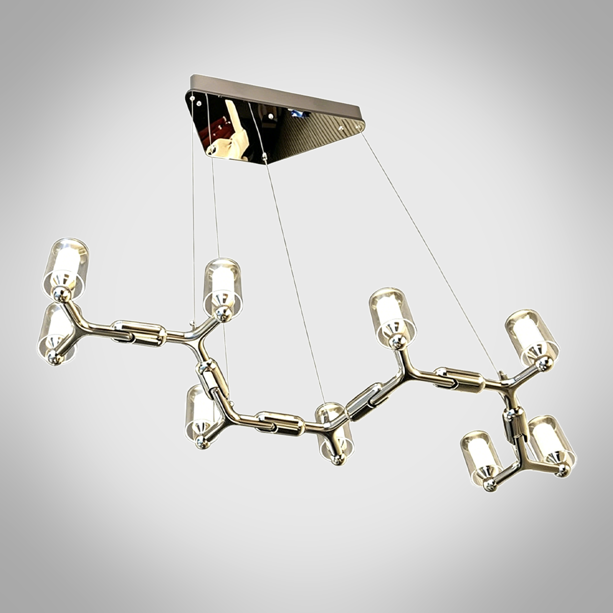 Glowing modern branching node linear LED chandelier with glass cylinder cups illuminated