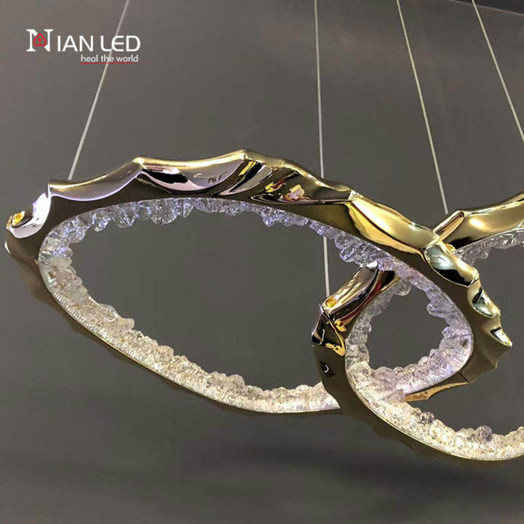 Close-up of interlocking gold zinc alloy rings with glowing crushed ice optical acrylic diffusers