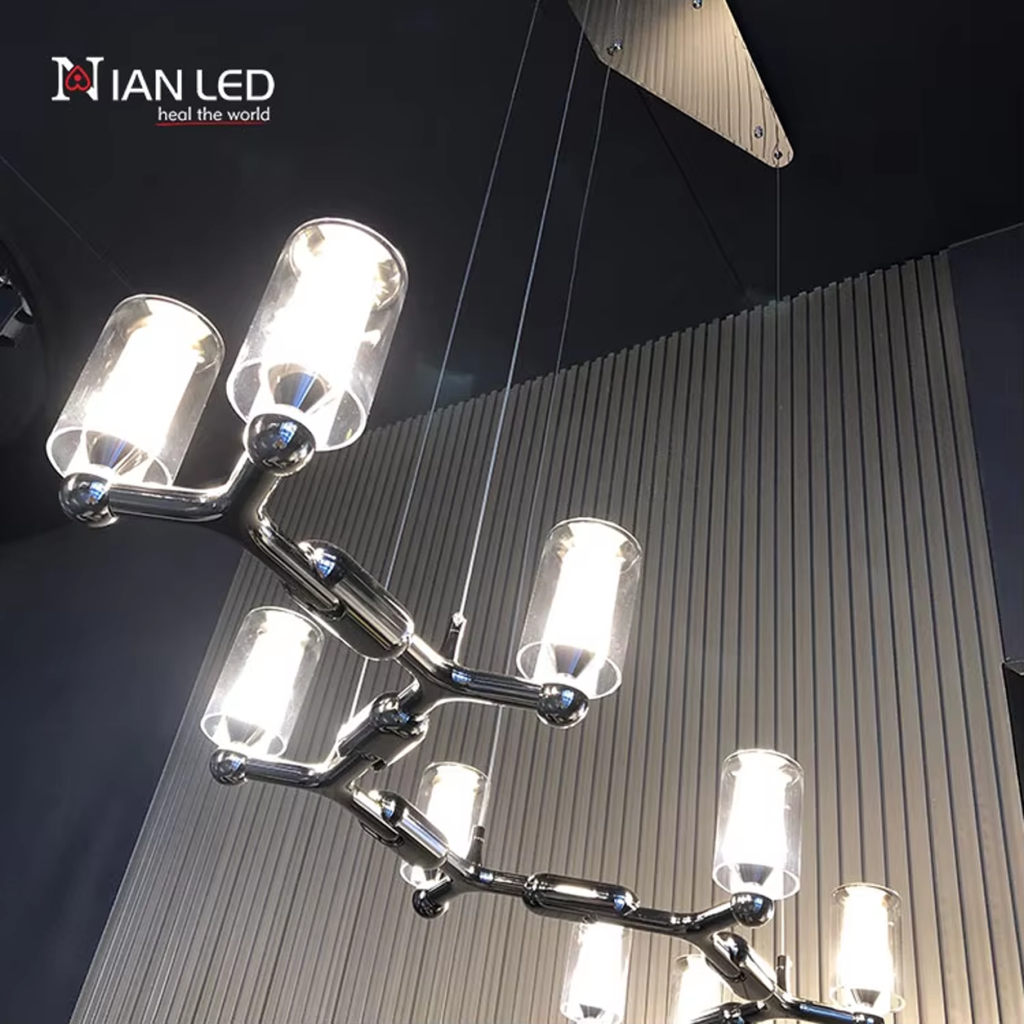 Glowing modern branching node linear LED chandelier with glass cylinder cups illuminated