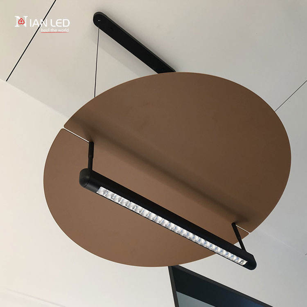 Bottom view of eclipse disc linear pendant showing precision-aligned lenses on black aluminum tube and bronze aluminum disc