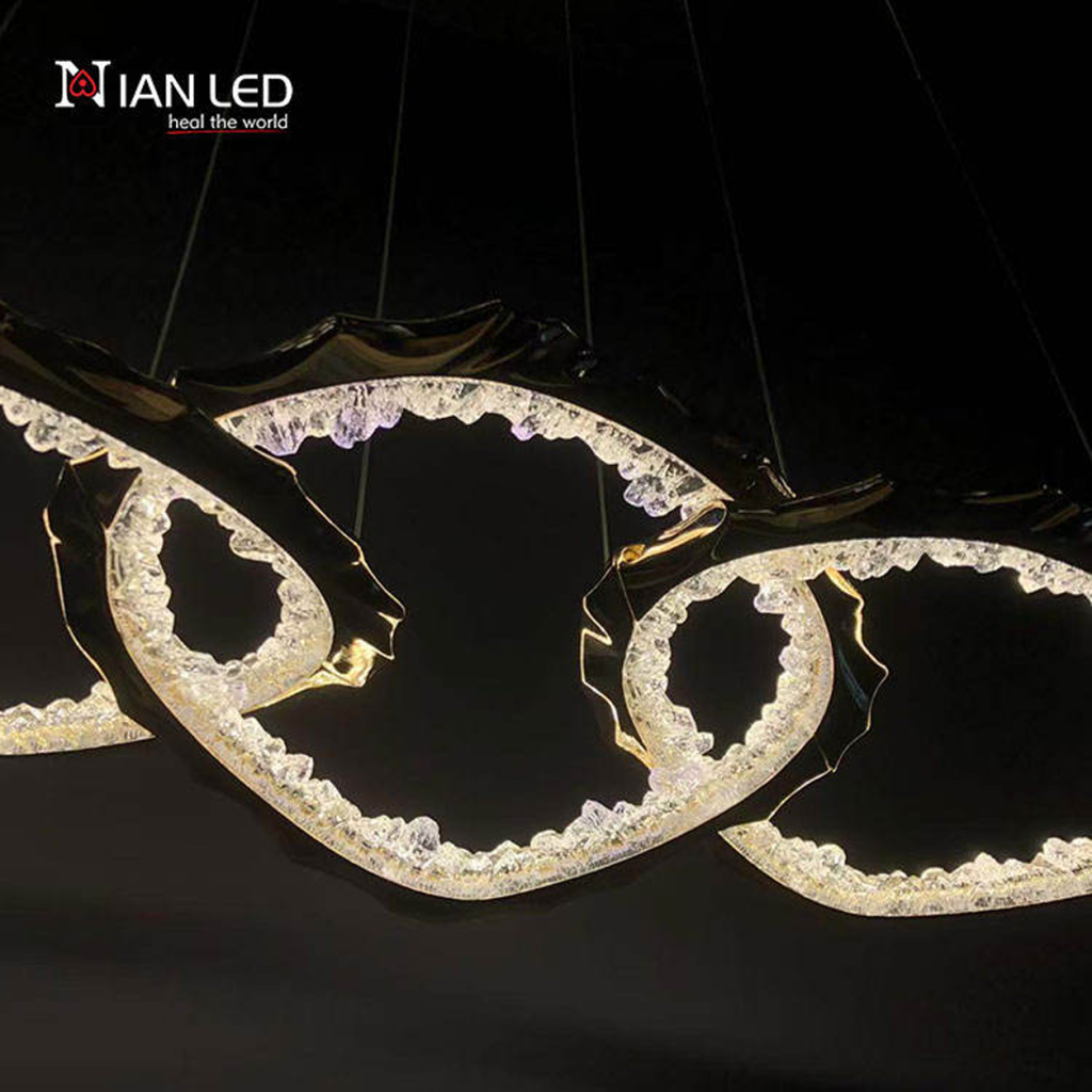 Close-up of interlocking gold zinc alloy rings with glowing crushed ice optical acrylic diffusers