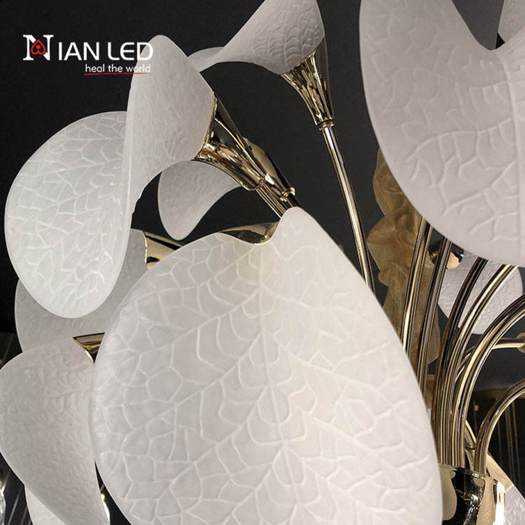 Close-up of frosted optical acrylic shade with leaf vein texture mounted on polished gold zinc alloy stem