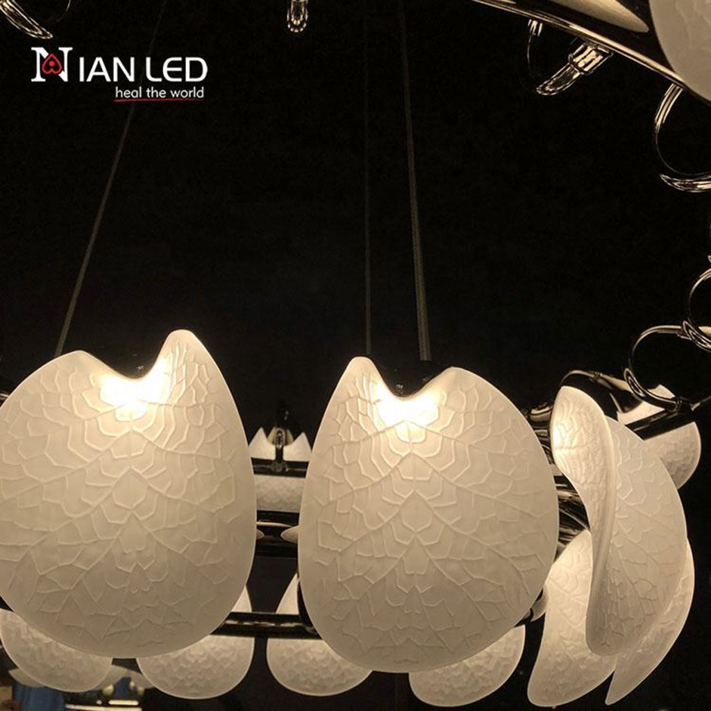 Close-up of etched optical acrylic leaf shade with vein texture attached to mirror-polished chrome steel ring frame