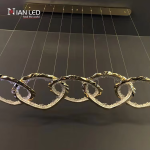 Linear view of gold wave chain pendant light showing multi-cable ceiling canopy suspension system