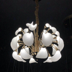 360 degree glowing spherical blooming petal LED chandelier with electroplated gold zinc alloy frame against dark background
