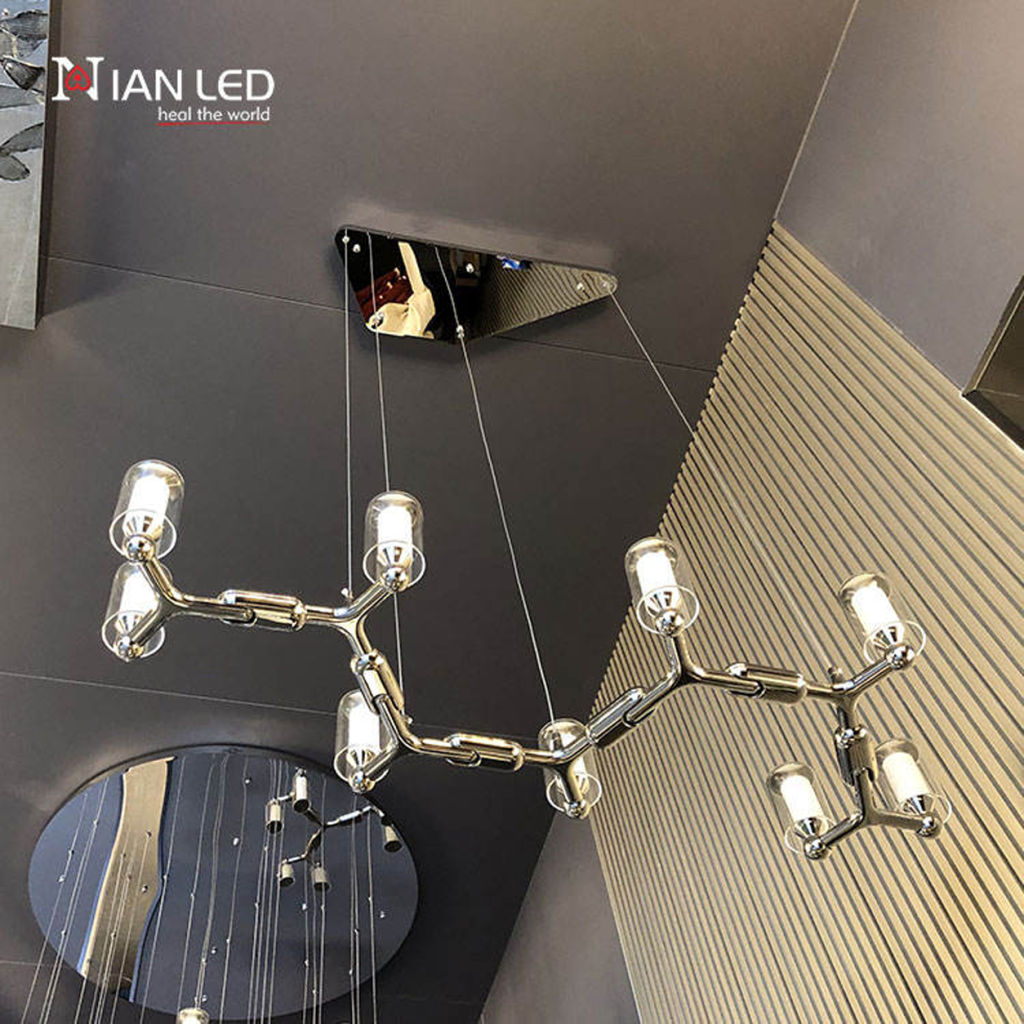 Glowing modern branching node linear LED chandelier with glass cylinder cups illuminated
