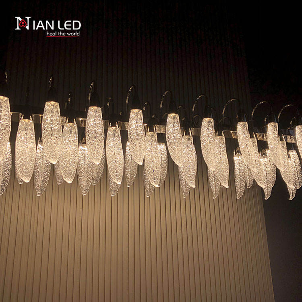 Detailed close-up of glowing glass-like optical acrylic feather shade with ice texture on polished zinc alloy mount