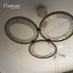 Upward view of brushed champagne gold aluminum rings with textured glass panel and integrated aluminum downlight junction