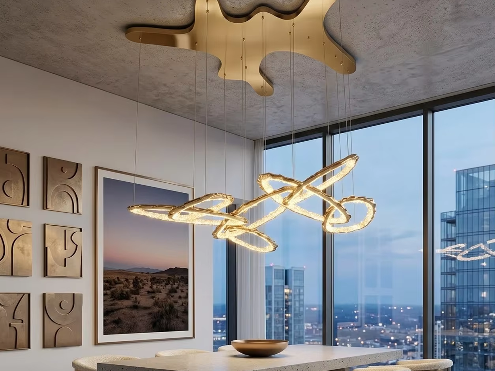 Upward view of modern gold ribbon LED chandelier suspended from matching organic shaped canopy with multi-loop wave design