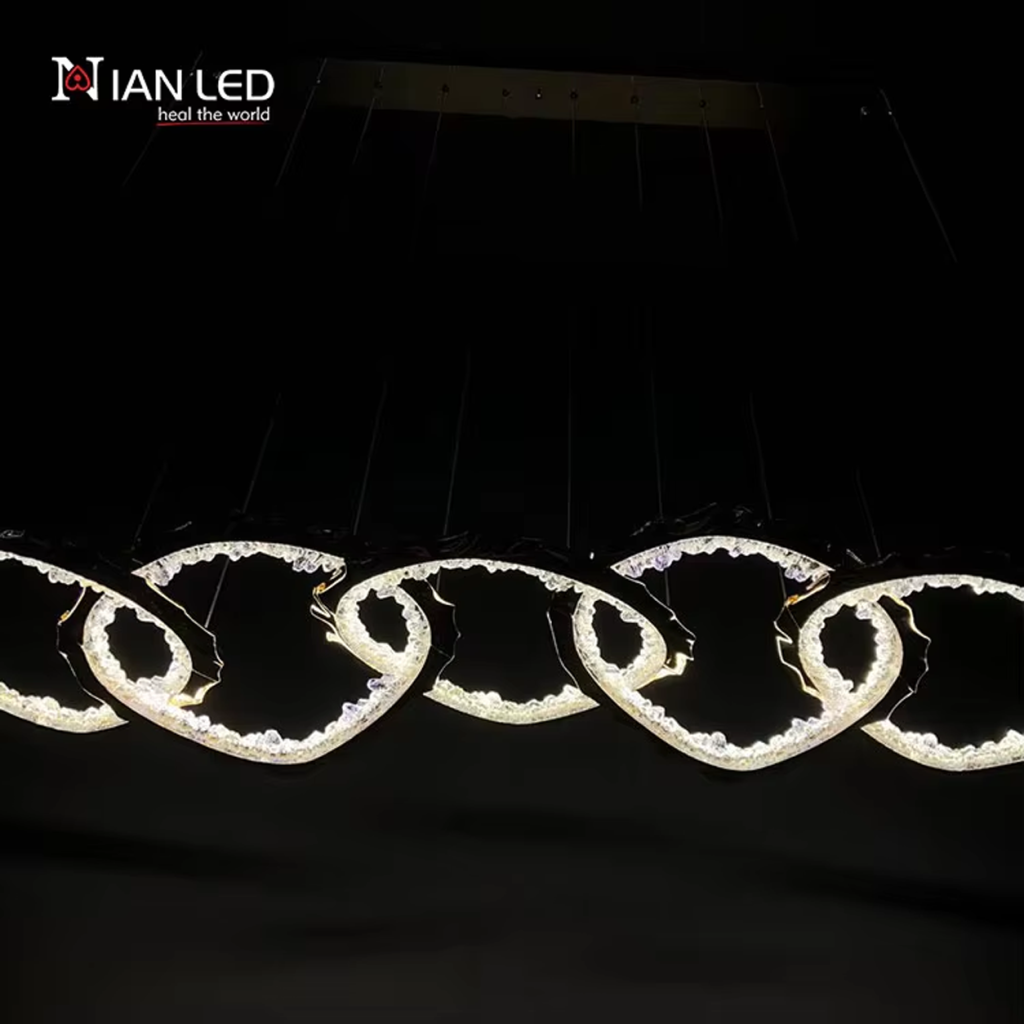Linear view of gold wave chain pendant light showing multi-cable ceiling canopy suspension system