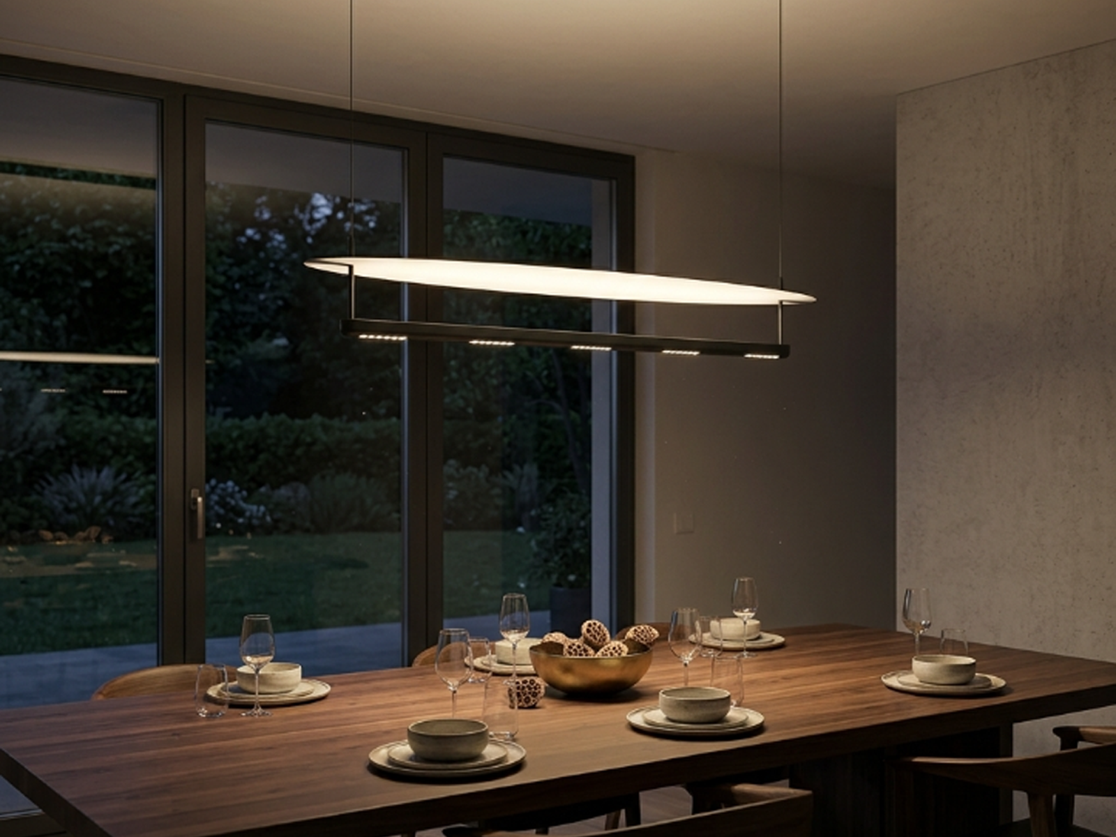 Minimalist 1200mm First Light series linear LED pendant light in tactile grey and sand black hanging over a modern dining desk
