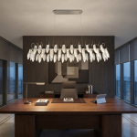 Large crystal-texture feather linear LED chandelier hanging above a luxury marble hotel reception desk in a contemporary lobby