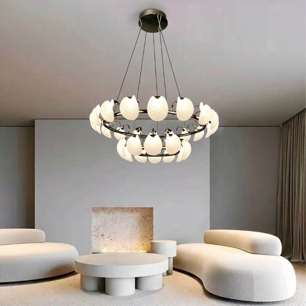 Two-tier leaf-vein halo ring LED chandelier with chrome steel frame hanging in a modern luxury living room above a grey leather sofa